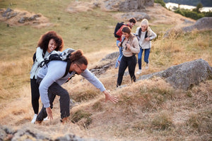 Group of hikers on a grassy hill.